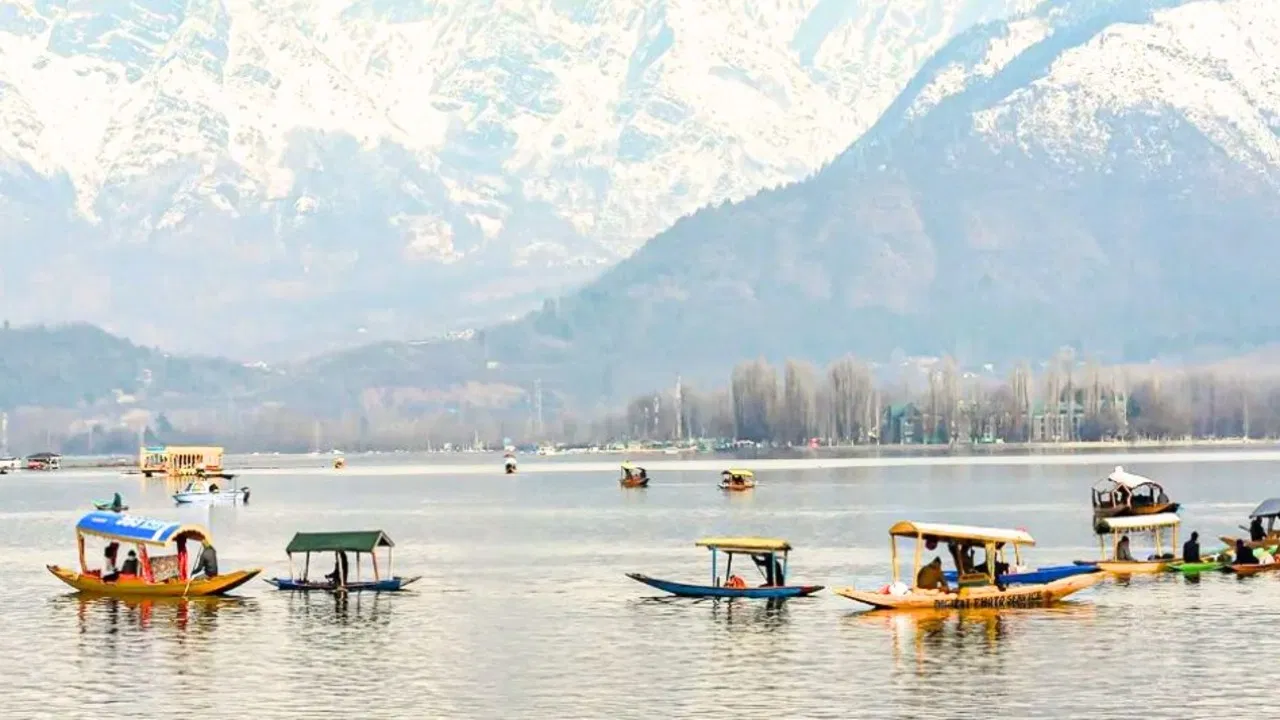 Dal Lake with boats and mountains in the background
